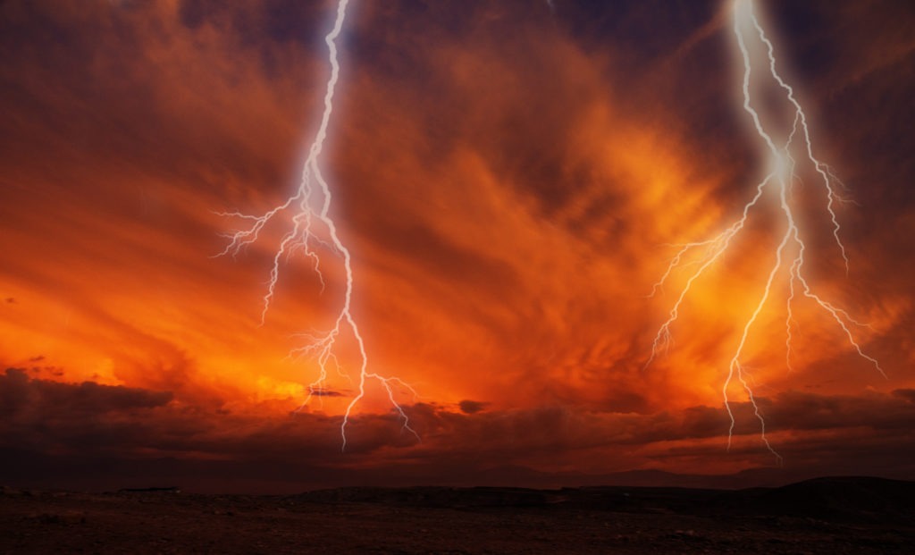 Lightning on a dark orange atmosphere.